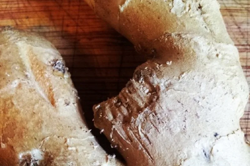 Fresh ginger root sliced on a wooden cutting board