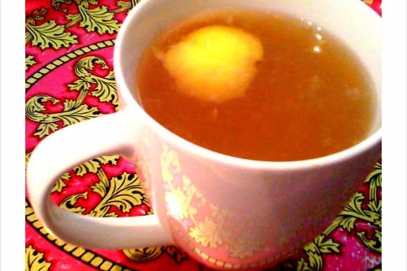 Cup of warm lemon and honey tea on a decorative tray, a remedy for boosting immunity in winter